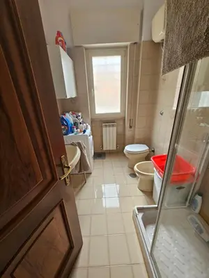 a small bathroom with a toilet and a window at CS Banco Apartment in Rome
