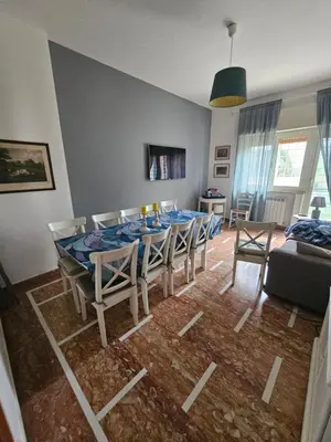 a dining room with a table and chairs at CS Banco Apartment in Rome