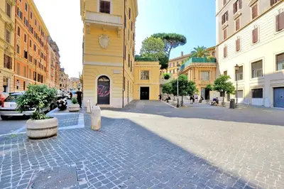 a cobblestone street in a city with buildings at Colosseum Studio in Rome