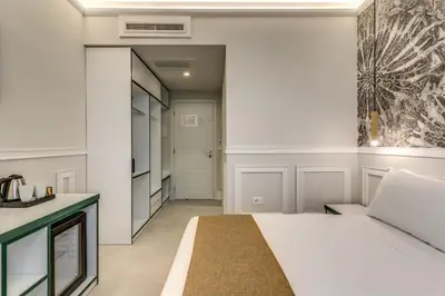 a bedroom with a bed and a hallway at Relais Marco Polo in Rome
