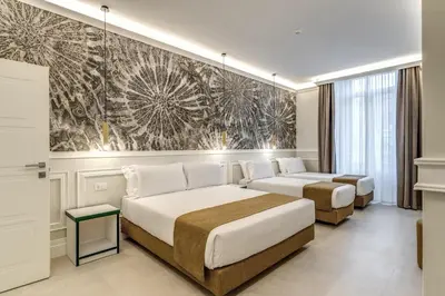 a bedroom with two beds and a painting on the wall at Relais Marco Polo in Rome