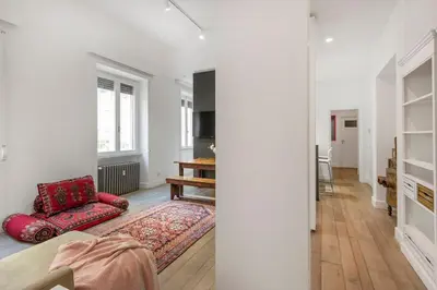 a living room with a red chair and a rug at Bordeaux luxury apartment Rome in Rome