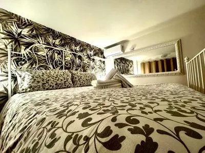 a bedroom with a large bed with a large headboard at Machiavelli House in Rome