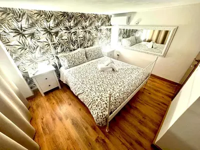 a small bedroom with a bed and a mirror at Machiavelli House in Rome