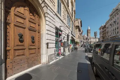 a building with a large wooden door on a street at CS Central Station Termini Monti Apartment in Rome