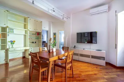 a kitchen and dining room with a wooden table and chairs at iFlat Vatican Comfortable & Peaceful Retreat in Rome