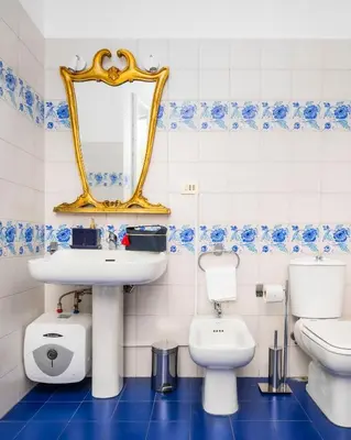 a bathroom with a sink and a toilet and a mirror at Luxury house Empire 96 in Rome