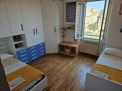a dorm room with two beds and a window at Luminoso attico con terrazza in Rome