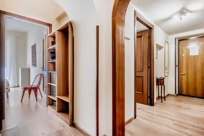 a room with a hallway with a door and a chair at Elegant flat in front of Vatican museum in Rome