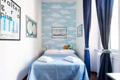 a bedroom with a bed with blue walls and clouds at Grande appartamento a Trastevere in Rome