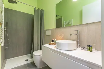 a bathroom with a sink and a toilet and a shower at Giada - Charming Apartment at the Imperial Forums in Rome