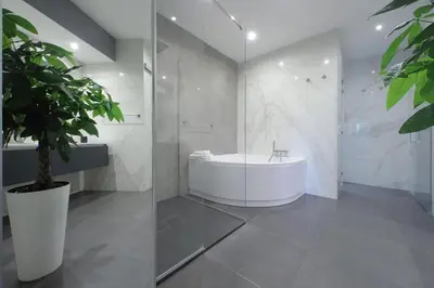 a bathroom with a tub and a potted plant at YCH-Exclusive apartment on Circus Maximus in Rome