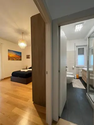 a bedroom with a bed and a bathroom at Casa Conca D Oro in Rome