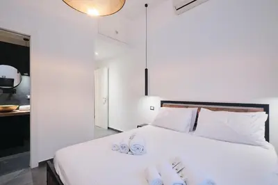 a bedroom with a white bed with towels on it at Elegante appartamento a pochi passi dal Centro in Rome