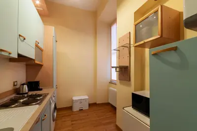a small kitchen with a stove and a refrigerator at GuestHost - Historic Apartment in Sallustiano in Rome