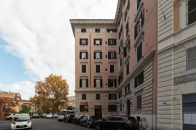 a tall building with cars parked on a city street at GuestHost - Historic Apartment in Sallustiano in Rome