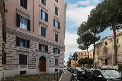 a building on the side of a street with parked cars at GuestHost - Historic Apartment in Sallustiano in Rome