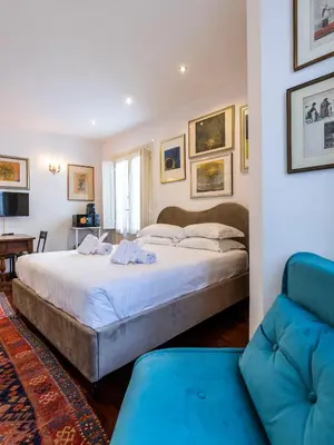 a bedroom with a large bed and a couch at FCR Rome Apartments Loft Campo de' Fiori - Monserrato in Rome