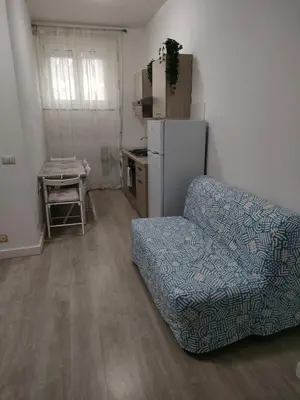 a living room with a couch and a refrigerator at Casa Flegrei in Rome