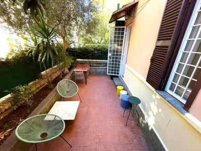 a patio with tables and chairs on a house at Cozy artsy apt near the Vatican in Rome