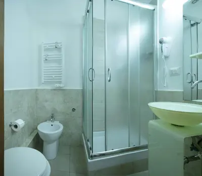 a bathroom with a toilet sink and a shower at Lorenzo's Rooms in Vatican in Rome