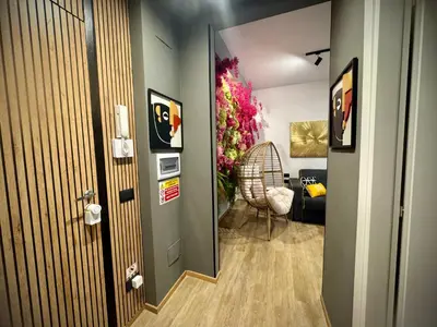 a hallway leading to a living room with a plant at Mabi - Roma San Paolo Centro in Rome
