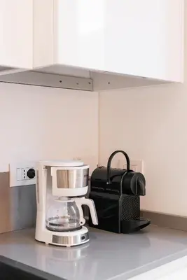 a coffee maker on a counter in a kitchen at The Vatican Rest, Elegant Apt Nerby the Basilica in Rome