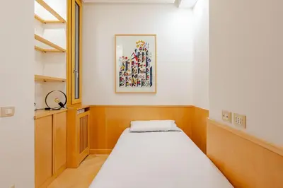 a small room with a bed and a painting on the wall at Casa Maddalena luxury appartment in Rome