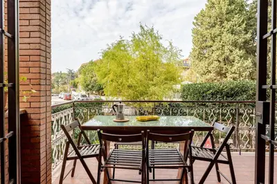 a patio table with two chairs on a balcony at Casa Maddalena luxury appartment in Rome