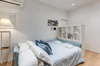 a bedroom with a blue bed and white walls at Residenza Margherita in Rome