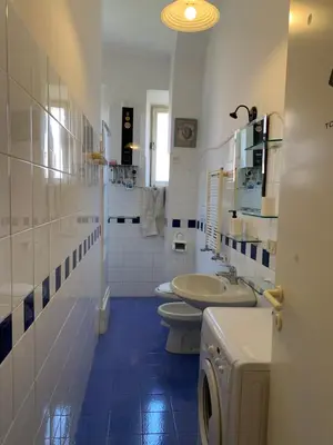 a white bathroom with two toilets and a sink at Flat nearby Vaticano - Caracciolo 4 in Rome