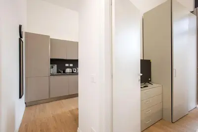 a laptop and a book on a table with a book at Urban Oasis near Termini, Free Parking&Balcony, int10 in Rome
