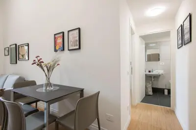 a tray of bread and two cups and a magazine on a bed at Urban Oasis near Termini, Free Parking&Balcony, int10 in Rome