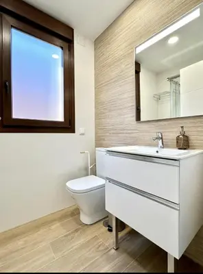 a bathroom with a toilet and a sink and a mirror at Il CIGNO in Rome