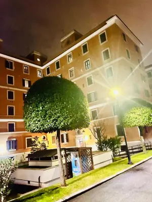 a large building with a tree in front of it at Fast Re Apartment in Rome