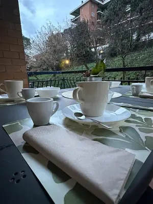 a table with cups and saucers on top at A casa di Lù in Rome