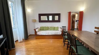 a living room with a couch and a table with chairs at Domus Leonis in Rome