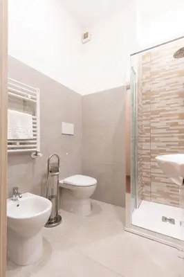 a bathroom with a toilet and a sink and a shower at Albio House - Nido Per 6PPL 3BTH in Rome