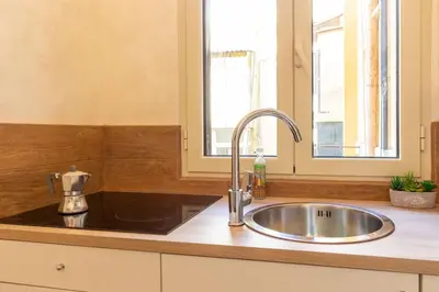 a kitchen counter with a sink and a window at Albio House - Nido Per 6PPL 3BTH in Rome