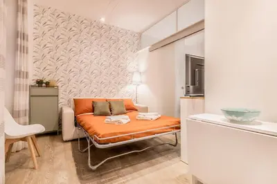 a living room with an orange couch in a room at Vatican Chic House II in Rome
