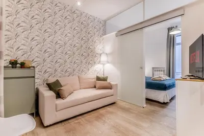 a living room with a couch and a bedroom at Vatican Chic House II in Rome