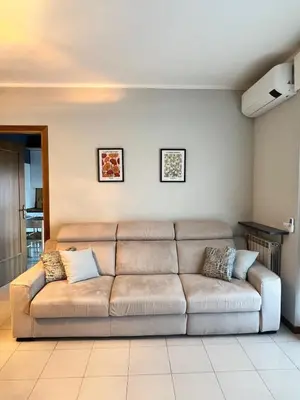 a living room with a brown couch in a room at The BestaHouse in Rome