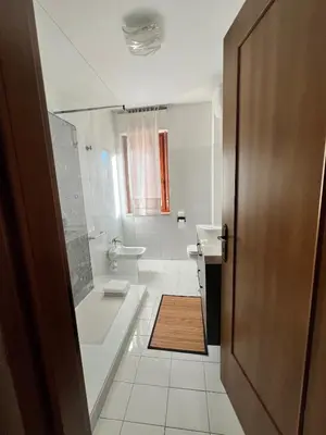 a bathroom with a tub and a toilet and a sink at The BestaHouse in Rome
