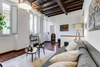 a living room with a couch and a table at 5 min Piazza Navona-Aria Condizionata-Smart TV-Cucina completa in Rome