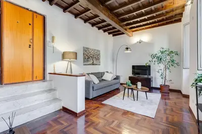 a living room with a couch and a table at 5 min Piazza Navona-Aria Condizionata-Smart TV-Cucina completa in Rome