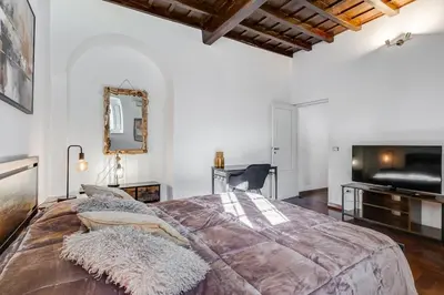 a bedroom with a large bed and a mirror at 5 min Piazza Navona-Aria Condizionata-Smart TV-Cucina completa in Rome