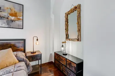 a bedroom with a dresser and a mirror on the wall at 5 min Piazza Navona-Aria Condizionata-Smart TV-Cucina completa in Rome