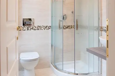 a bathroom with a toilet and a glass shower at Domus Trevi in Rome