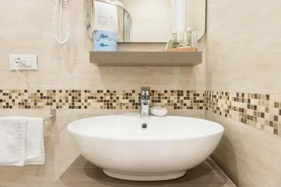 a bathroom with a white sink and a mirror at Domus Trevi in Rome