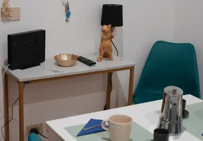 a table with a cat figurine sitting on top of it at Via Lattea Vatican Apartment - Family friendly in Rome